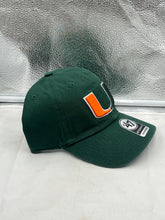 Load image into Gallery viewer, Miami Hurricanes NCAA &#39;47 Brand Green Clean Up Adjustable Hat worn by a fan at a game, demonstrating team pride and stylish versatility.
