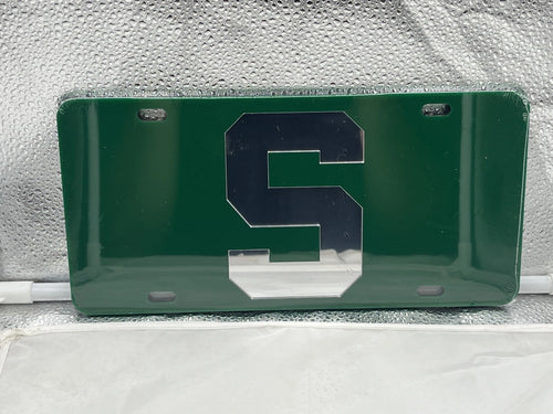 Michigan State Spartans NCAA Green Mirrored Laser Cut License Plate by Craftique, showcasing vibrant green finish and laser-cut Michigan State logo, perfect for fans and vehicle decoration.