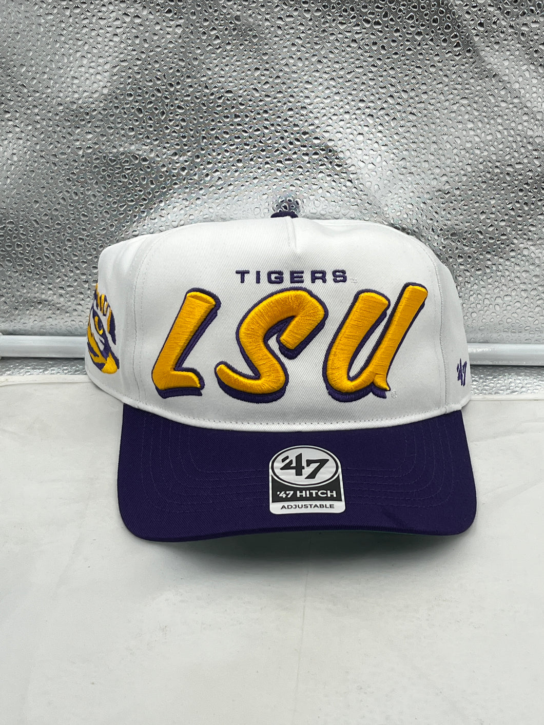 LSU Tigers NCAA '47 Brand White Two Tone Script Hitch Adjustable Snapback Hat displayed against a neutral background, showcasing its stylish design and vibrant colors.