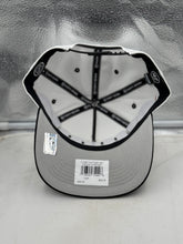 Load image into Gallery viewer, Model wearing the Carolina Hurricanes NHL '47 Brand White Diamond Hitch Adjustable Snapback Hat at a sports event, showcasing team spirit and style.
