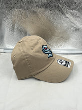 Load image into Gallery viewer, Seattle Kraken NHL &#39;47 Brand Khaki Clean Up Adjustable Hat worn by a fan at a game.
