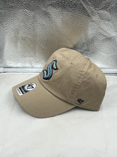 Load image into Gallery viewer, Close-up view of the khaki color fabric of the Seattle Kraken NHL &#39;47 Brand Clean Up Adjustable Hat.
