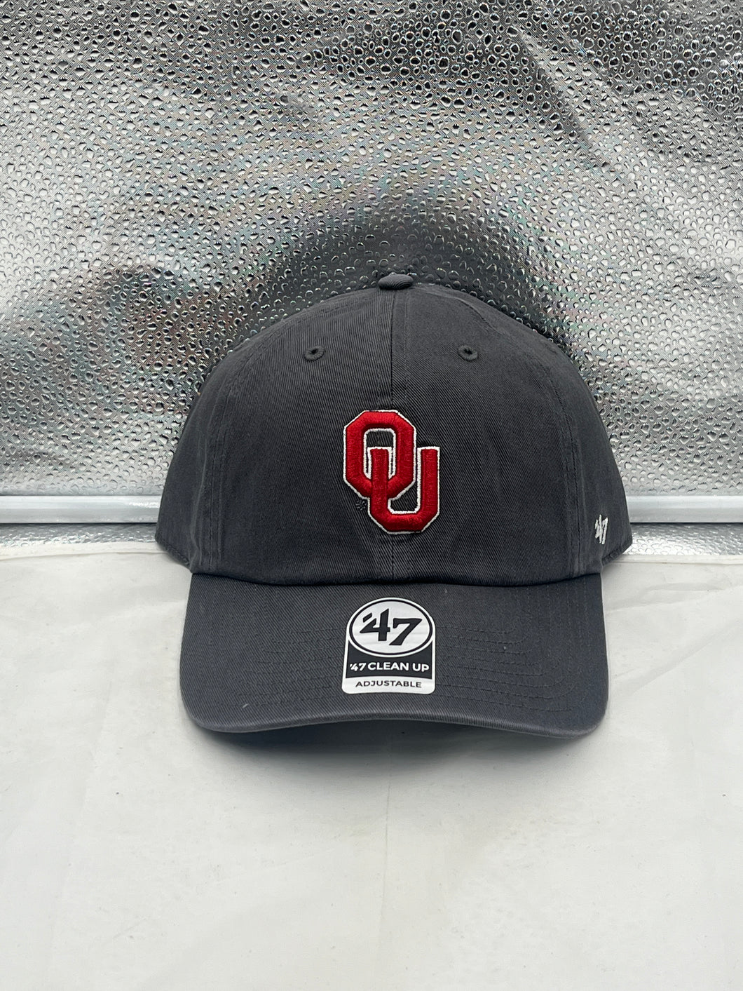 Oklahoma Sooners NCAA '47 Brand Gray Clean Up Adjustable Strapback Hat showcasing the team's logo and adjustable strap for a comfortable fit, perfect for game day and casual wear.