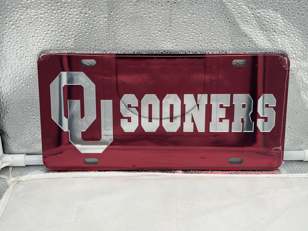 Oklahoma Sooners NCAA Red Mirrored Laser Cut License Plate Craftique showcasing the vibrant red mirrored finish and official team logo, perfect for displaying team spirit on your vehicle.