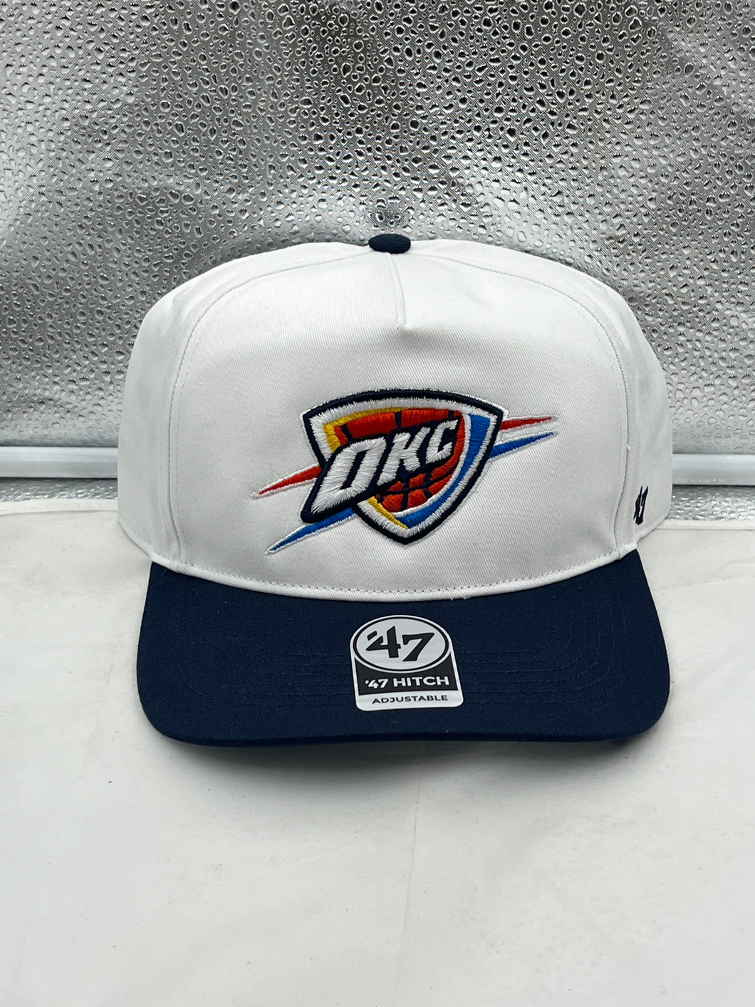 Oklahoma City Thunder NBA '47 Brand White Two Tone Hitch Adjustable Snapback Hat displayed on a clean background, showcasing the bold team logo.