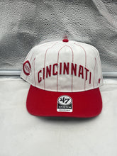 Load image into Gallery viewer, Cincinnati Reds MLB &#39;47 Brand White TT Script Hitch Adjustable Snapback Hat displayed on a wooden table with a baseball and gloves in the background.
