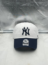 Load image into Gallery viewer, New York Yankees MLB &#39;47 Brand Natural White Two Tone Clean Up Adjustable Hat showcasing a stylish two-tone design in natural white and team colors, perfect for game day and casual outings.
