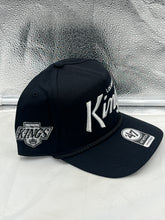 Load image into Gallery viewer, Los Angeles Kings NHL &#39;47 Brand Black Script Hitch Rope Adjustable Snapback Hat worn by a fan, emphasizing team spirit.
