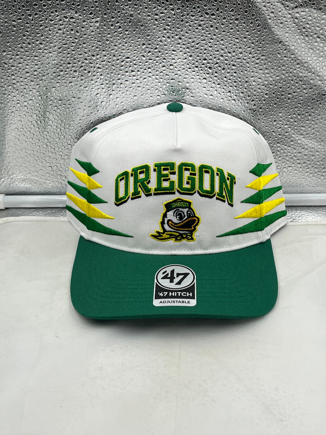 Oregon Ducks NCAA '47 Brand White Diamond Hitch Snapback Adjustable Hat displayed with vibrant colors and intricate design, perfect for fans and outdoor activities.