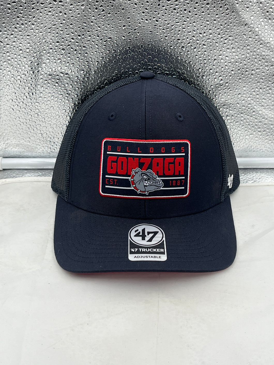Gonzaga Bulldogs NCAA '47 Brand Navy Blue Trucker Mesh Adjustable Hat showcasing the bold team logo on the front, perfect for dedicated fans.