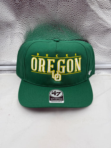 Oregon Ducks NCAA '47 Brand Green Hitch City Line Adjustable Snapback Hat displayed on a table, highlighting its vibrant green color and adjustable design, perfect for any Oregon Ducks hat fan.