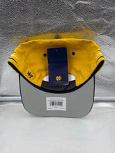 Load image into Gallery viewer, Person wearing the Notre Dame Fighting Irish NCAA &#39;47 Gold Diamond Hitch Snapback Adjustable Hat while representing team spirit at an outdoor event.
