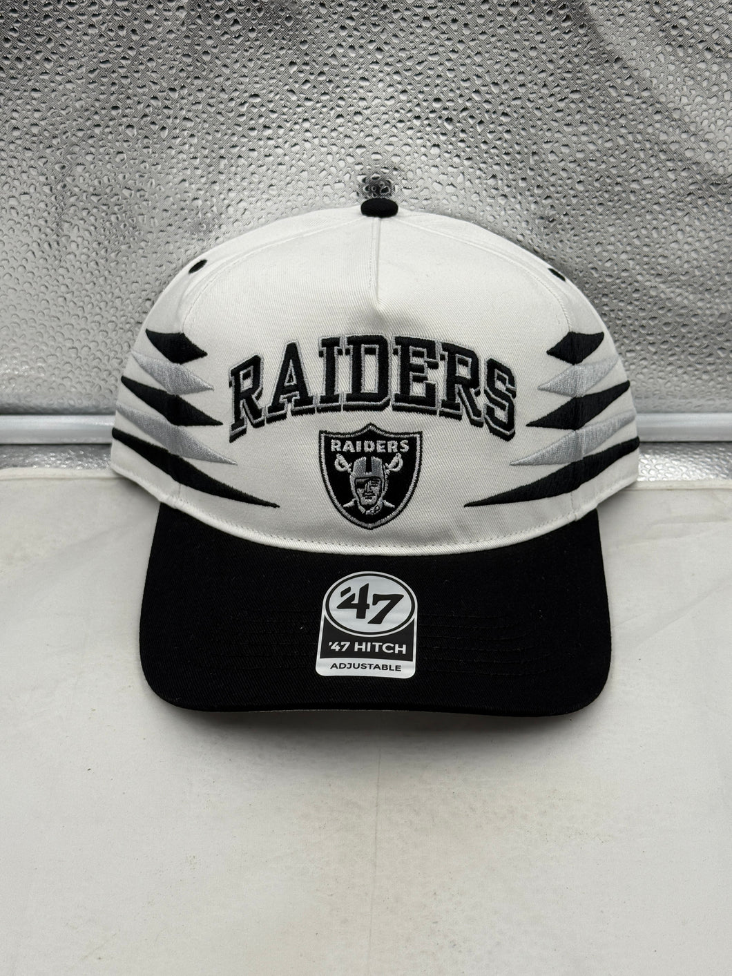 Las Vegas Raiders NFL '47 Brand White TT Diamond Hitch Snapback Adjustable Hat displayed on a mannequin to showcase its stylish design and Raiders logo.