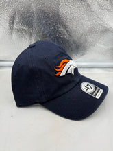 Load image into Gallery viewer, Denver Broncos NFL '47 Brand Navy Blue Clean Up Adjustable Strapback Hat on a sunny outdoor setting, perfect for game day or tailgating as an essential Denver Broncos hat.
