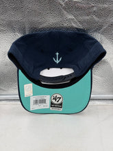 Load image into Gallery viewer, Person wearing the Seattle Kraken NHL '47 Brand Corduroy Navy Hitch Adjustable Snapback Hat at an outdoor game event, demonstrating its comfort and stylish look.

