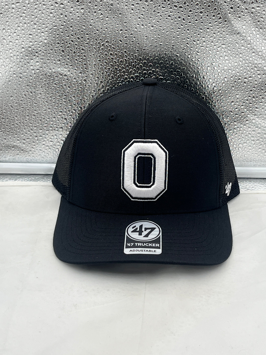 Ohio State Buckeyes NCAA '47 Brand Black Trucker Adjustable Snapback Hat featuring a prominent team logo on the front and breathable mesh back.