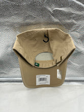 Load image into Gallery viewer, Dallas Stars NHL &#39;47 Brand Khaki Clean Up Adjustable Strapback Hat worn by a fan, emphasizing team pride and casual style at a game.

