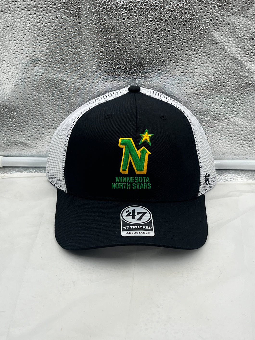 Minnesota North Stars NHL '47 Brand Black Trucker Mesh Adjustable Snapback Hat displayed on a white background, showcasing the team logo and adjustable snapback design.