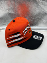 Load image into Gallery viewer, Baltimore Orioles MLB '47 Brand Orange TT Diamond Hitch Adjustable Snapback Hat worn by a fan at a baseball game, emphasizing team loyalty.
