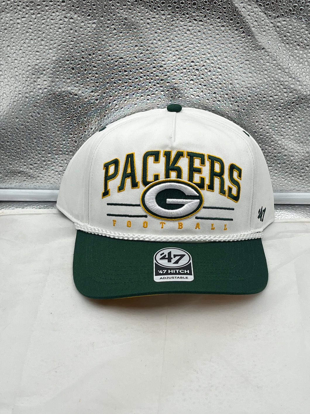 Green Bay Packers NFL '47 White TT Roscoe Hitch Rope Snapback Adjustable Hat displayed at a 45-degree angle, showcasing its classic white color and prominent Packers logo for fans.