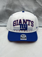 Load image into Gallery viewer, New York Giants NFL &#39;47 White TT Roscoe Hitch Rope Snapback Adjustable Hat displayed on a wooden surface with vibrant team logo.
