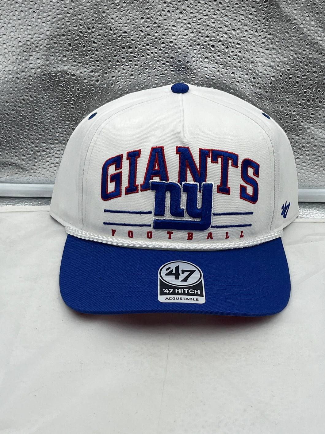New York Giants NFL '47 White TT Roscoe Hitch Rope Snapback Adjustable Hat displayed on a wooden surface with vibrant team logo.