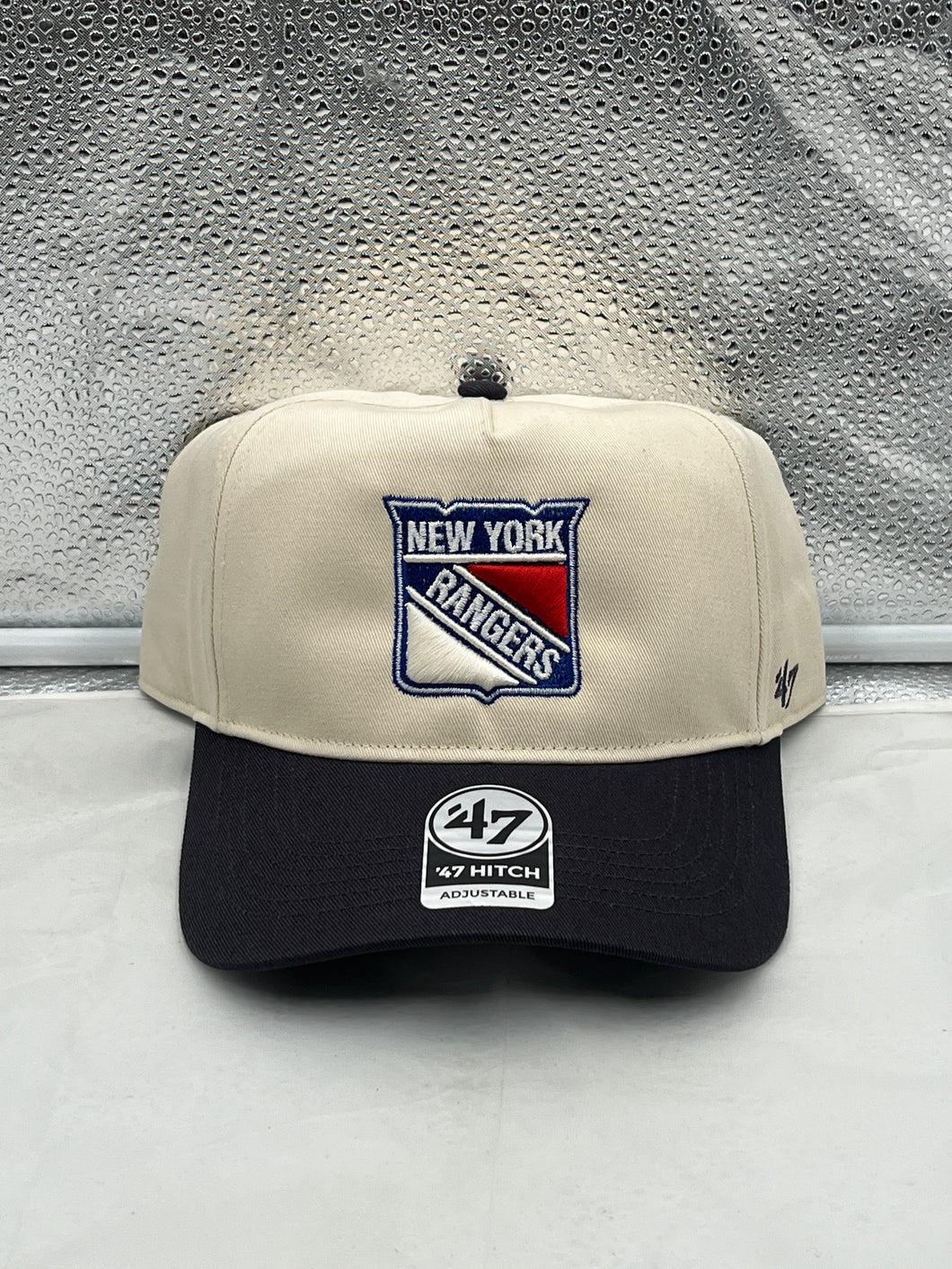 a new york rangers hat sitting on top of a counter