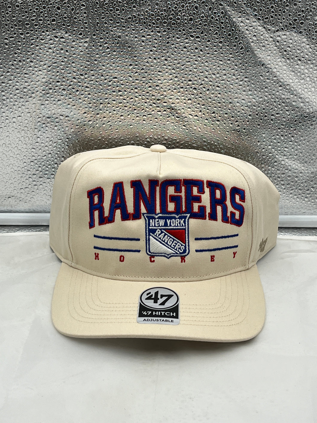 a new york rangers baseball cap sitting on top of a counter