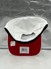 Load image into Gallery viewer, a red and white hat sitting on top of a window sill
