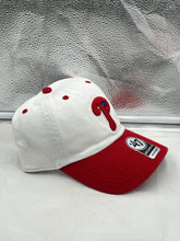 Load image into Gallery viewer, a red and white baseball hat sitting on top of a window sill
