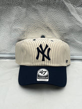 Load image into Gallery viewer, a new york yankees baseball cap sitting on top of a bed
