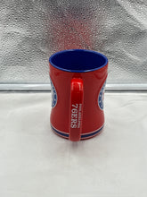 Load image into Gallery viewer, a red and blue cup sitting on top of a counter
