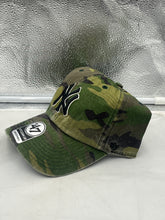 Load image into Gallery viewer, a camo hat sitting on top of a white counter
