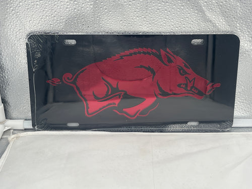 Arkansas Razorbacks NCAA Black Mirrored Laser Cut License Plate by Craftique showcasing a sleek mirrored finish and intricate laser-cut design featuring the iconic Razorbacks logo, ideal for demonstrating team pride on vehicles or as home decor.
