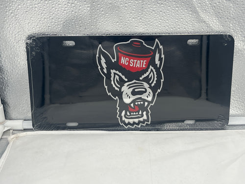 NC State Wolfpack NCAA Black Mirrored Laser Cut License Plate from Craftique, showcasing a sleek, modern design with a laser-cut logo, perfect for displaying school spirit and vehicle personalization.