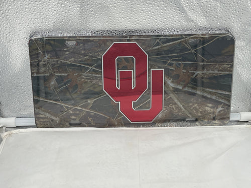 Oklahoma Sooners NCAA Camo Mirrored Laser Cut License Plate by Craftique showcasing a stylish camo design with a reflective finish, perfect for showcasing team spirit on any vehicle.