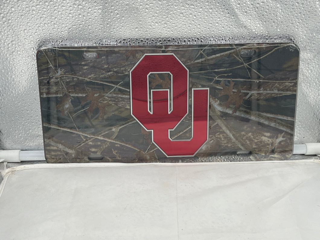 Oklahoma Sooners NCAA Camo Mirrored Laser Cut License Plate by Craftique showcasing a stylish camo design with a reflective finish, perfect for showcasing team spirit on any vehicle.