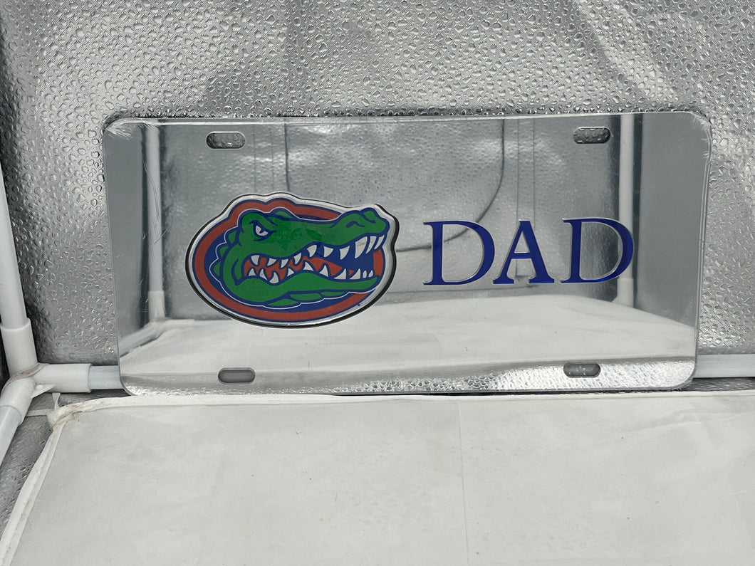Florida Gators NCAA Silver Mirrored Laser Cut License Plate by Craftique showcasing a sleek silver finish and intricate laser-cut design featuring the iconic Gators logo, perfect for adding collegiate flair to any vehicle.