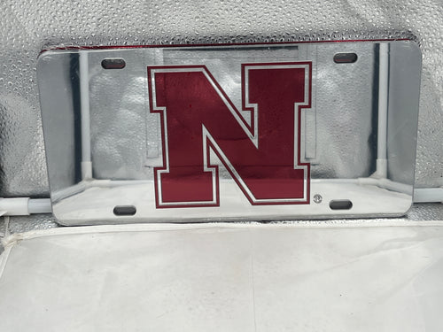 Nebraska Cornhuskers NCAA Silver Mirrored Laser Cut License Plate by Craftique displaying the iconic logo in a sleek mirrored finish.