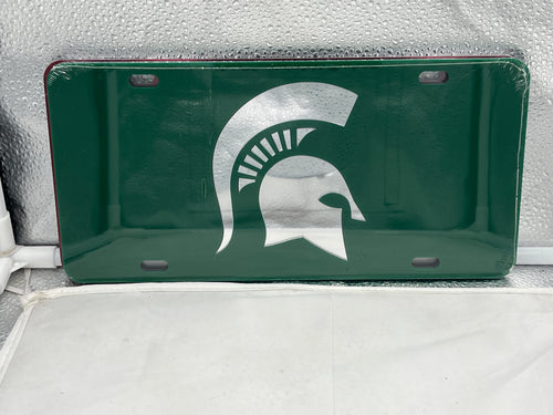 Michigan State Spartans NCAA Green Mirrored Laser Cut License Plate from Craftique showcasing vibrant green color and elegant laser-cut design, perfect for vehicle decoration and team pride.