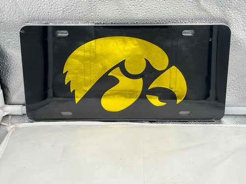 Iowa Hawkeyes NCAA Black Mirrored Laser Cut License Plate from Craftique showcasing the elegant black mirror finish and precise laser-cut Iowa Hawkeyes logo, perfect for vehicle decoration.