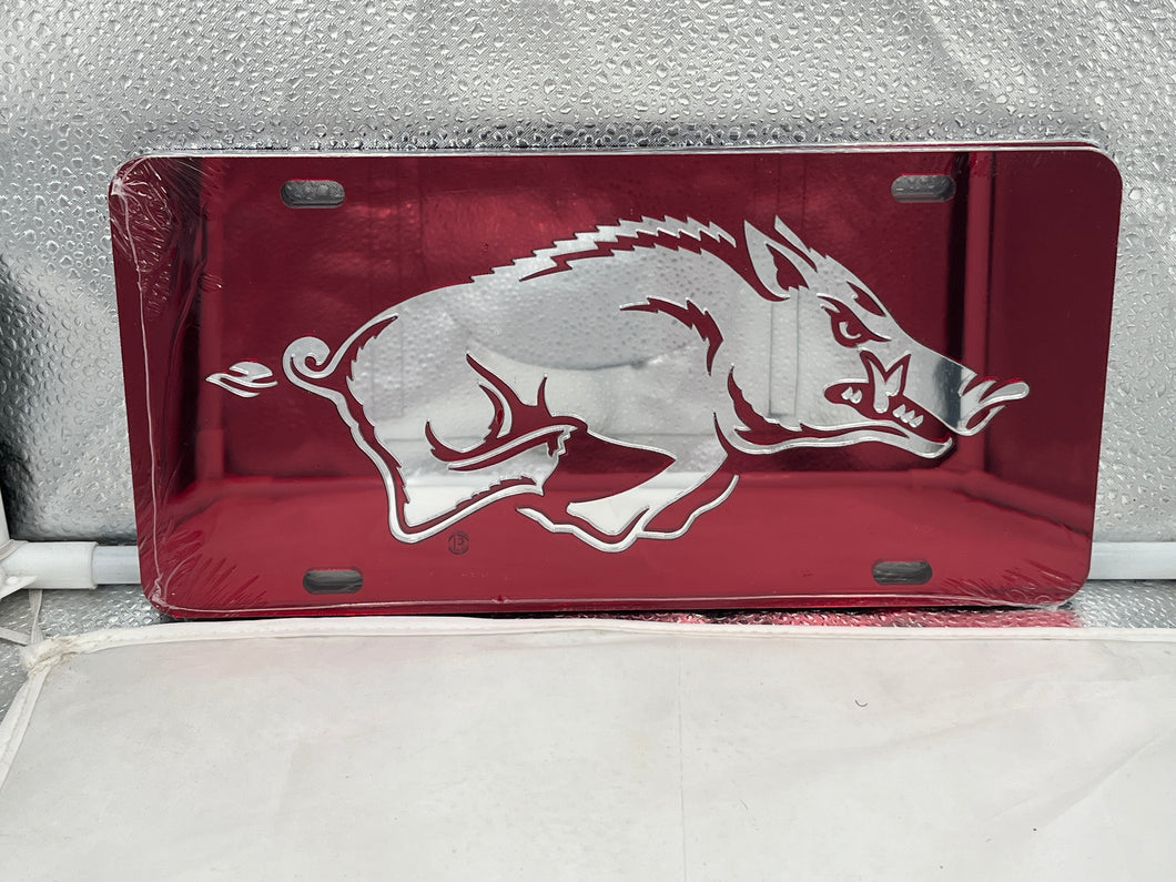 Arkansas Razorbacks NCAA Red Mirrored Laser Cut License Plate Craftique, featuring vibrant red color and detailed laser-cut logo design, perfect for showcasing team spirit on vehicles.