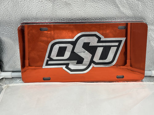 Oklahoma State Cowboys NCAA Orange Mirrored Laser Cut License Plate Craftique showcasing vibrant orange mirrored finish and intricate Cowboys logo design, perfect accessory for team pride on vehicles.