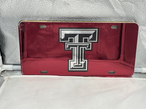 Texas Tech Red Raiders NCAA Red Mirrored Laser Cut License Plate by Craftique, featuring a vibrant red background and precise laser-cut detailing of the Texas Tech emblem, perfect for showcasing team spirit.