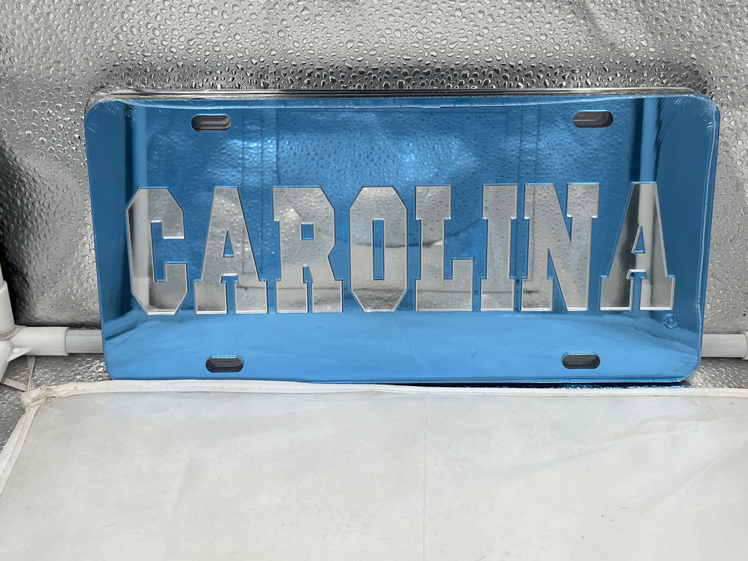 North Carolina Tar Heels NCAA Blue Mirrored Laser Cut License Plate from Craftique, showcasing the iconic Tar Heels logo with a striking mirrored finish, perfect for fans.