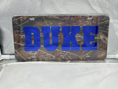 Duke Blue Devils NCAA Camo Acrylic Laser Cut License Plate from Craftique showcasing durable construction and vibrant camo design for team spirit display.