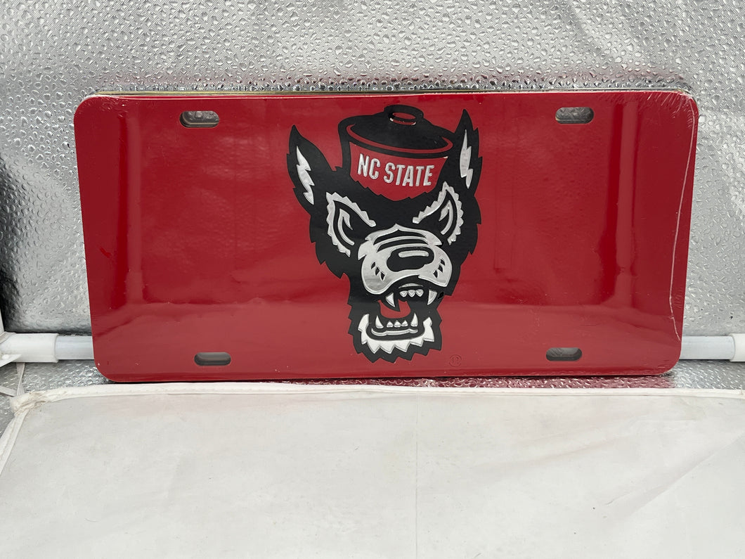NC State Wolfpack NCAA Red Mirrored Laser Cut License Plate by Craftique showcasing the iconic logo with a dazzling mirrored finish, perfect for displaying team spirit on vehicles.
