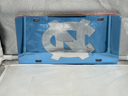 North Carolina Tar Heels NCAA Blue Mirrored Laser Cut License Plate by Craftique, showcasing vibrant blue mirrored finish and precise laser-cut design with iconic team logo.