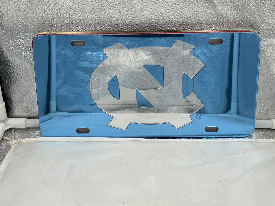 North Carolina Tar Heels NCAA Blue Mirrored Laser Cut License Plate by Craftique, showcasing vibrant blue mirrored finish and precise laser-cut design with iconic team logo.