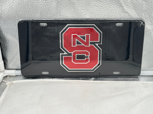 NC State Wolfpack NCAA Black Mirrored Laser Cut License Plate by Craftique, showcasing a sleek and modern design with the team's iconic logo, perfect for vehicle decoration and displaying team pride.